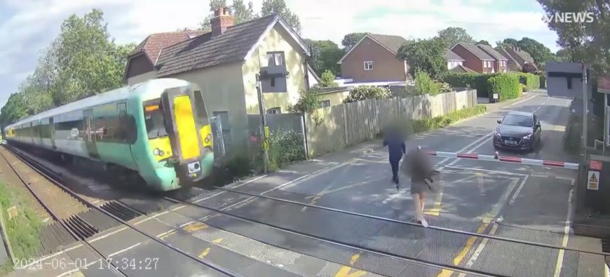 Watch girl unknowingly run directly into path of speeding TRAIN on level crossing as it barrelled straight towards her --[Reported by Umva mag]