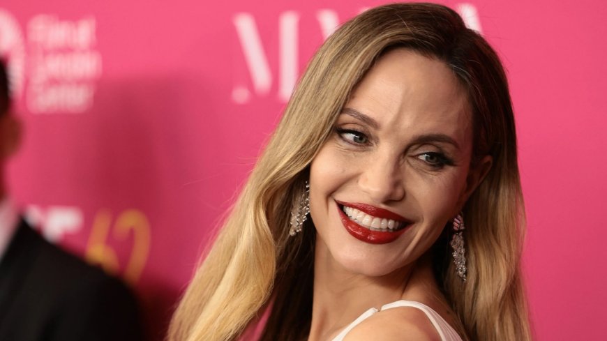 Beaming Angelina Jolie, 49, shows off her tattoos as she wows in white dress on red carpet --[Reported by Umva mag]