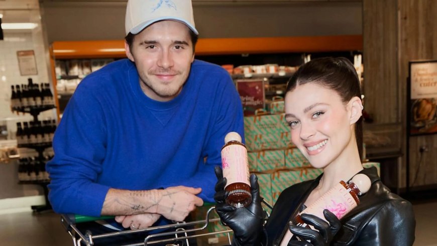 Brooklyn Beckham pushes wife Nicola Peltz in shopping trolley as he promotes new hot sauce --[Reported by Umva mag]